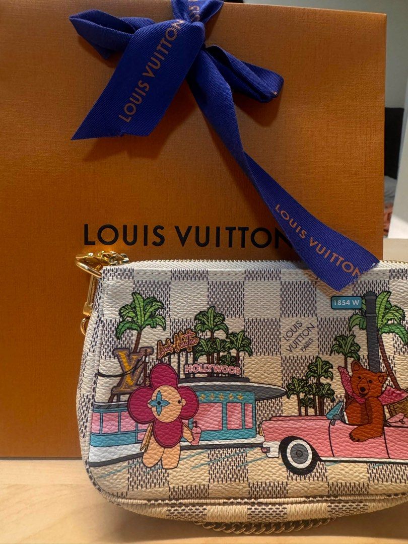 Louis Vuitton Mini Pochette Accessoires (Category: Luxury Bags & Wallets) located in Taguig. Submitted by luxeria_ (Listing ID 1409422611, Image 1). Description: - Authentic Louis Vuitton Mini Pochette Accessoires - Unique Hollywood-themed design - Includes original Louis Vuitton box and ribbon - Features a checkered pattern with colorful illustrations - Gold-tone zipper and small strap - Ideal for carrying small essentials.