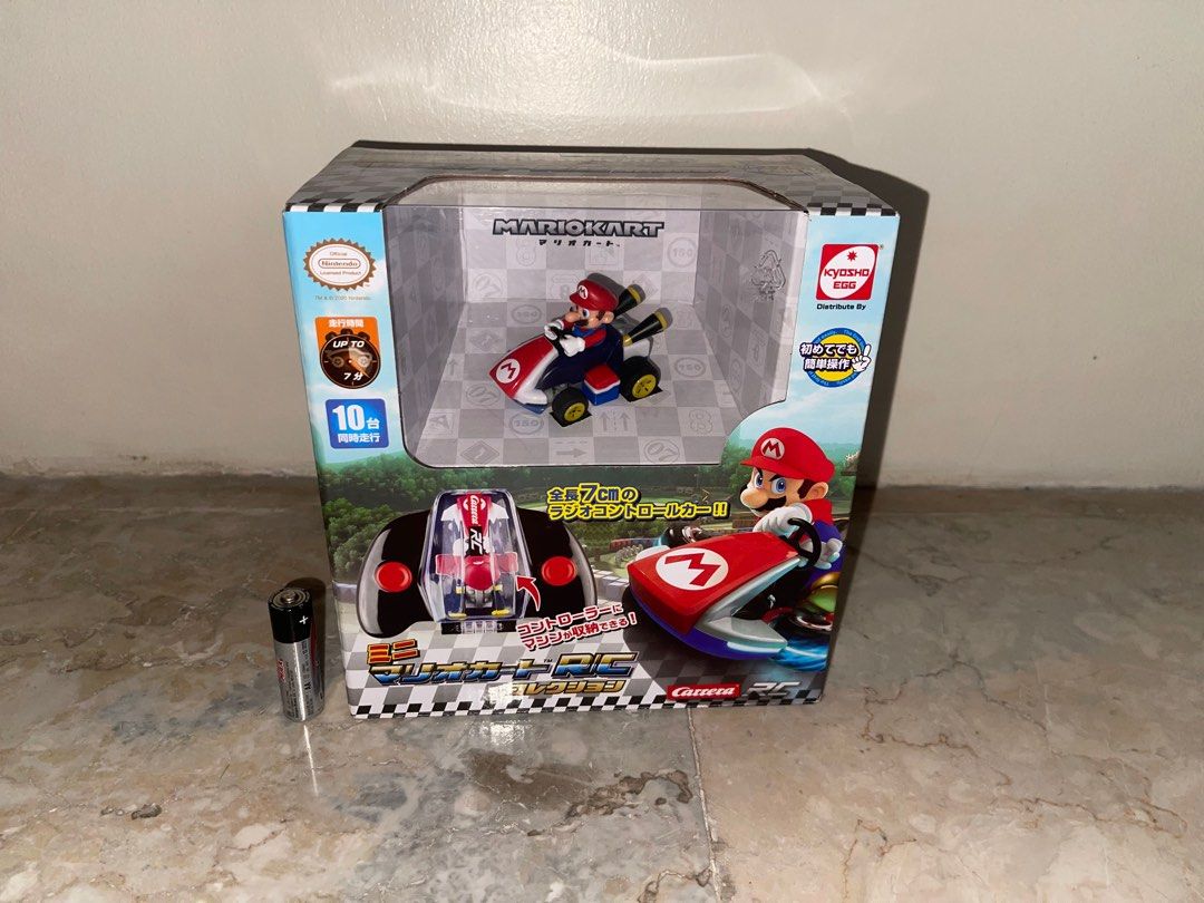 Mario Kart remote control RC Car Carrera (Category: Remote Control Toys) located in Pasay City. Submitted by j_wolf (Listing ID 1409432783, Image 1). Description: - Carrera Mario Kart RC Car - Includes car and remote control - USB charging cable included - Maximum speed: 5km/h - Suitable for ages 6+ - Remote control features a storage compartment.