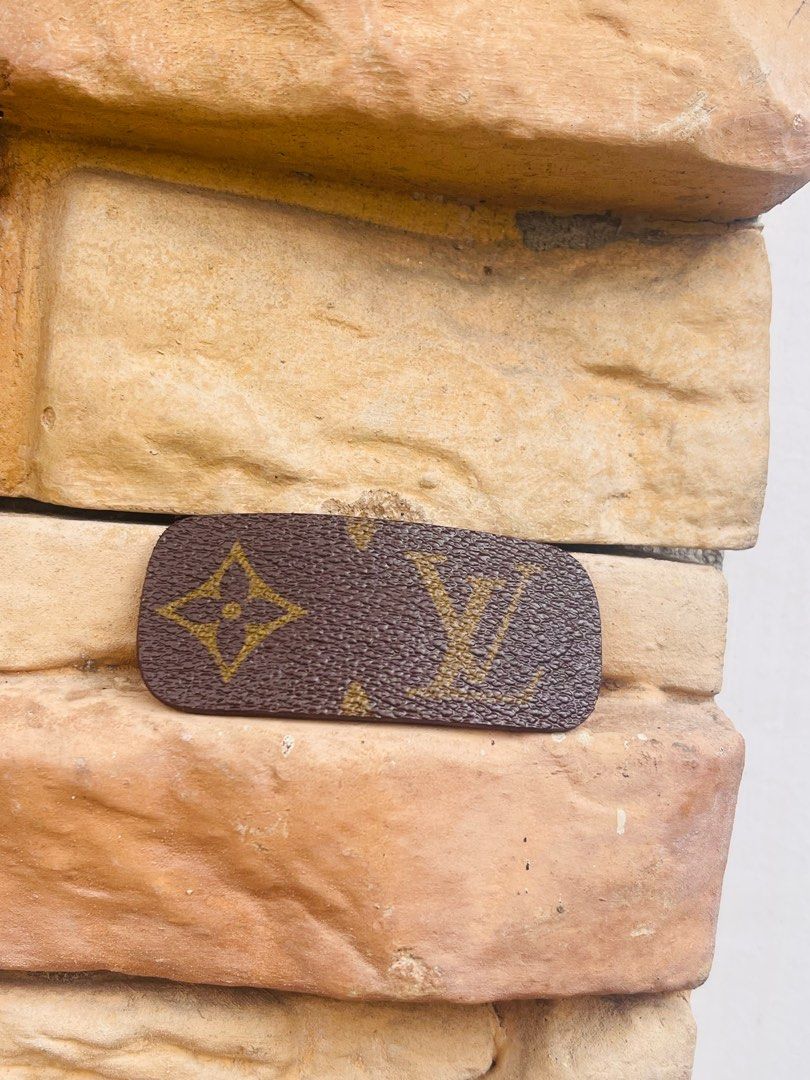 Repurposed Louis Vuitton Hair Clip (Category: Hair Accessories) located in Cavite. Submitted by authenticfindsbyging (Listing ID 1409434698, Image 1). Description: - Repurpose Louis Vuitton Monogram Hair Clip - Classic LV logo in gold on a brown background - Brown leather backing - Silver-tone metal clasp - Suitable for all hair types - Adds a touch of luxury to any hairstyle.