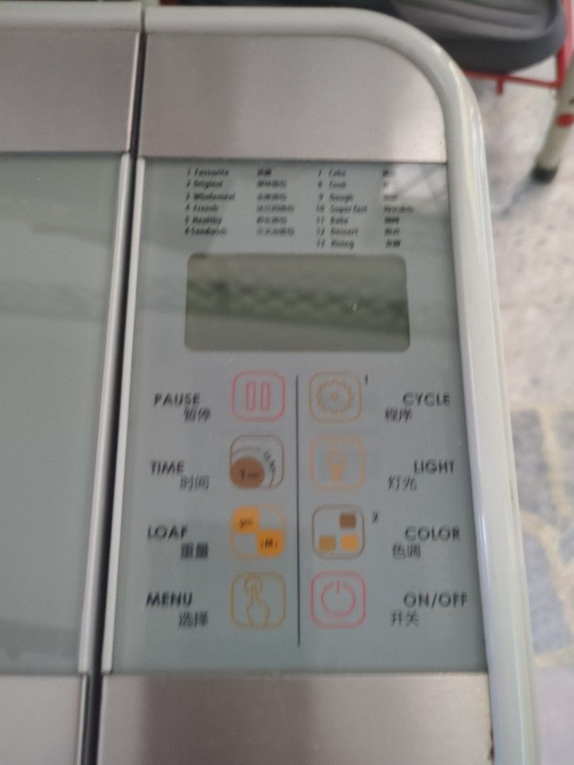 Smart Bread Maker (Category: Breadmakers) located in Gelugor. Submitted by shxie (Listing ID 1409351264, Image 2). Description: Bread maker features multiple settings for various bread types. It includes a timer function and options for light or dark crust. The machine has a removable bread pan and a separate compartment. It comes with a kneading paddle and a measuring spoon. The control panel has buttons for cycle, light, color, and on/off. tbh 