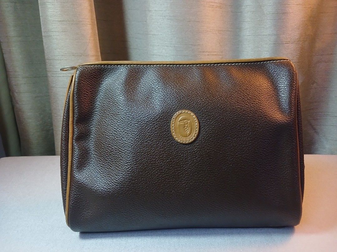 Trussardi Brown Cosmetic Bag (Category: Luxury Bags & Wallets) located in Plaridel. Submitted by collectors_blocc (Listing ID 1409317624, Image 1). Description: - Trussardi cosmetic bag - Brown exterior with tan accents - Made of leather - Zip closure - Features logo detail on the front - Interior with "Trussardi made in Italy" logo print.