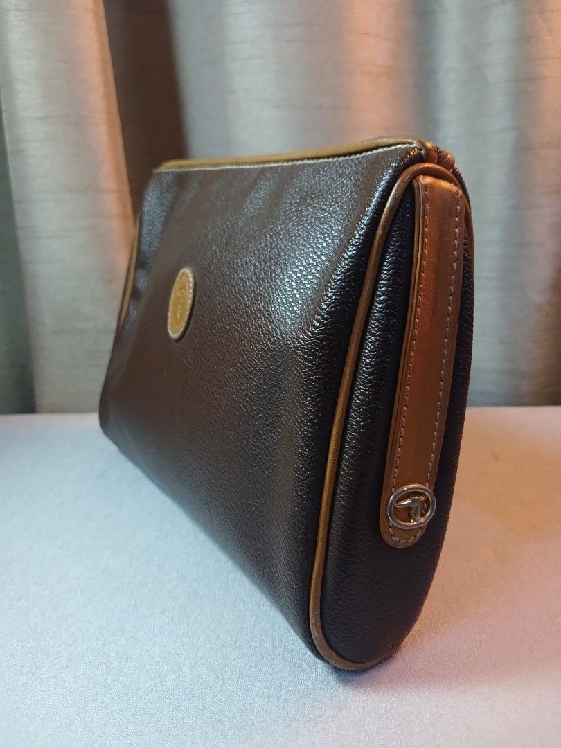 Trussardi Brown Cosmetic Bag (Category: Luxury Bags & Wallets) located in Plaridel. Submitted by collectors_blocc (Listing ID 1409317624, Image 3). Description: - Trussardi cosmetic bag - Brown exterior with tan accents - Made of leather - Zip closure - Features logo detail on the front - Interior with "Trussardi made in Italy" logo print.