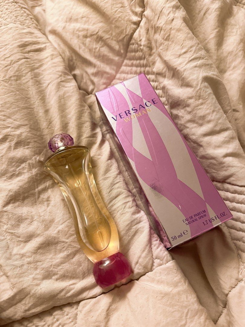 Versace Woman Eau de Parfum 50ml (LIGHTLY USED) (Category: Fragrance & Deodorants) located in Marikina City. Submitted by prelovedbyerickaa (Listing ID 1409413967, Image 2). Description: - Versace Woman Eau de Parfum - lightly used perfume - about 40ml left - Unique bottle design with purple stopper - Original pink and white box with Versace logo - Box includes QR code and details.