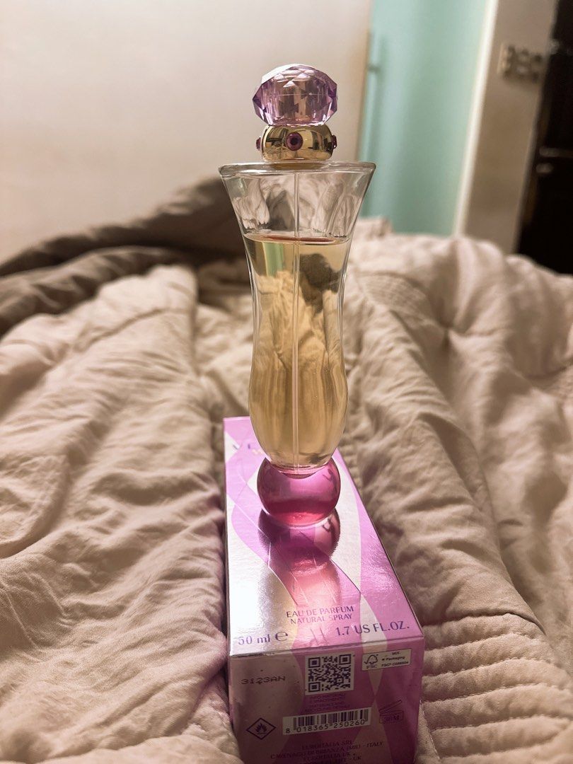 Versace Woman Eau de Parfum 50ml (LIGHTLY USED) (Category: Fragrance & Deodorants) located in Marikina City. Submitted by prelovedbyerickaa (Listing ID 1409413967, Image 3). Description: - Versace Woman Eau de Parfum - lightly used perfume - about 40ml left - Unique bottle design with purple stopper - Original pink and white box with Versace logo - Box includes QR code and details.
