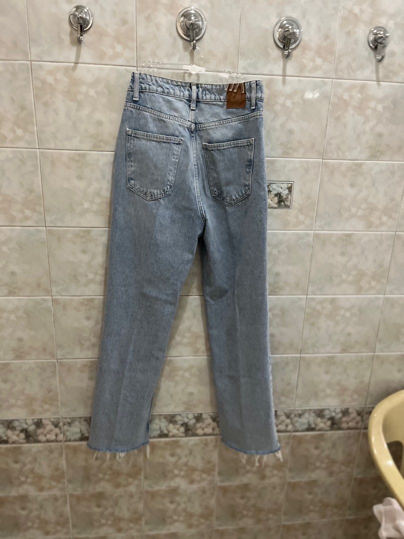 Zara Light Wash Straight Jeans (Category: Jeans) located in Manila. Submitted by jcmph (Listing ID 1409318263, Image 3). Description: Light wash Zara jeans. Features a straight leg fit with a raw hem. The jeans have a button and zipper closure. The label indicates a EUR size 36, USA size 4, and MEX size 26. Made in Turkey. Waist 27-28. High waist Length 41 inches .