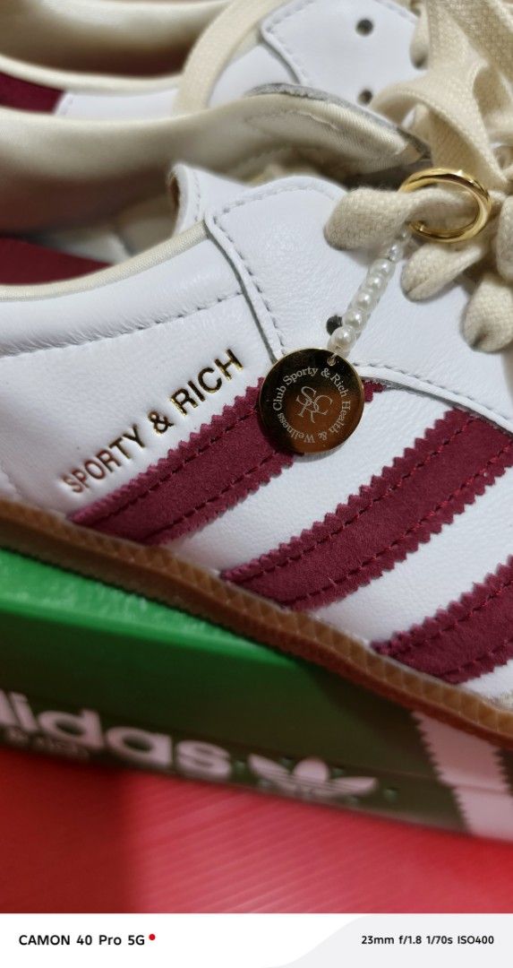 Adidas Samba x Sporty & Rich (Category: Sneakers) located in Pasig City. Submitted by rolandsells (Listing ID 1409470754, Image 2). Description: - Adidas Samba x Sporty & Rich collaboration - Classic white with maroon stripes - Features a cream-colored toe cap - Gum sole - Sporty & Rich logo detail - Comes with the original box - Box features Adidas and Sporty & Rich branding.
