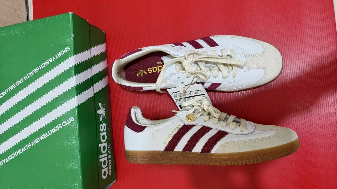 Adidas Samba x Sporty & Rich (Category: Sneakers) located in Pasig City. Submitted by rolandsells (Listing ID 1409470754, Image 1). Description: - Adidas Samba x Sporty & Rich collaboration - Classic white with maroon stripes - Features a cream-colored toe cap - Gum sole - Sporty & Rich logo detail - Comes with the original box - Box features Adidas and Sporty & Rich branding.