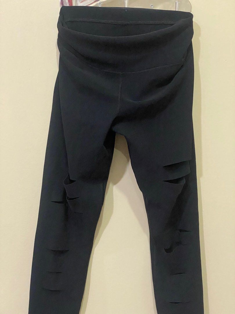 Alo Yoga Ripped Leggings - Black (Category: Activewear) located in Manila. Submitted by roseluxuryitems (Listing ID 1409505936, Image 2). Description: Black Alo Yoga leggings with ripped detailing . Made in Portugal. Features the Alo logo on the leg. Brand new condition From US .