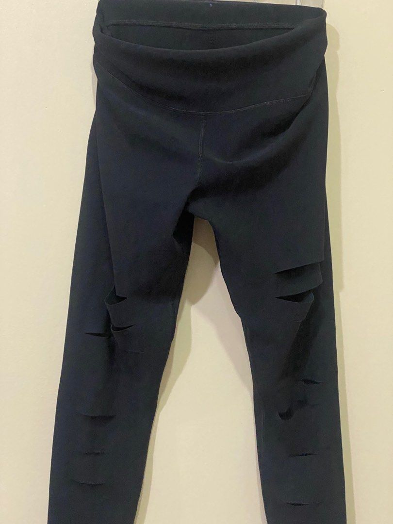 Alo Yoga Ripped Leggings - Black (Category: Activewear) located in Manila. Submitted by roseluxuryitems (Listing ID 1409505936, Image 3). Description: Black Alo Yoga leggings with ripped detailing . Made in Portugal. Features the Alo logo on the leg. Brand new condition From US .