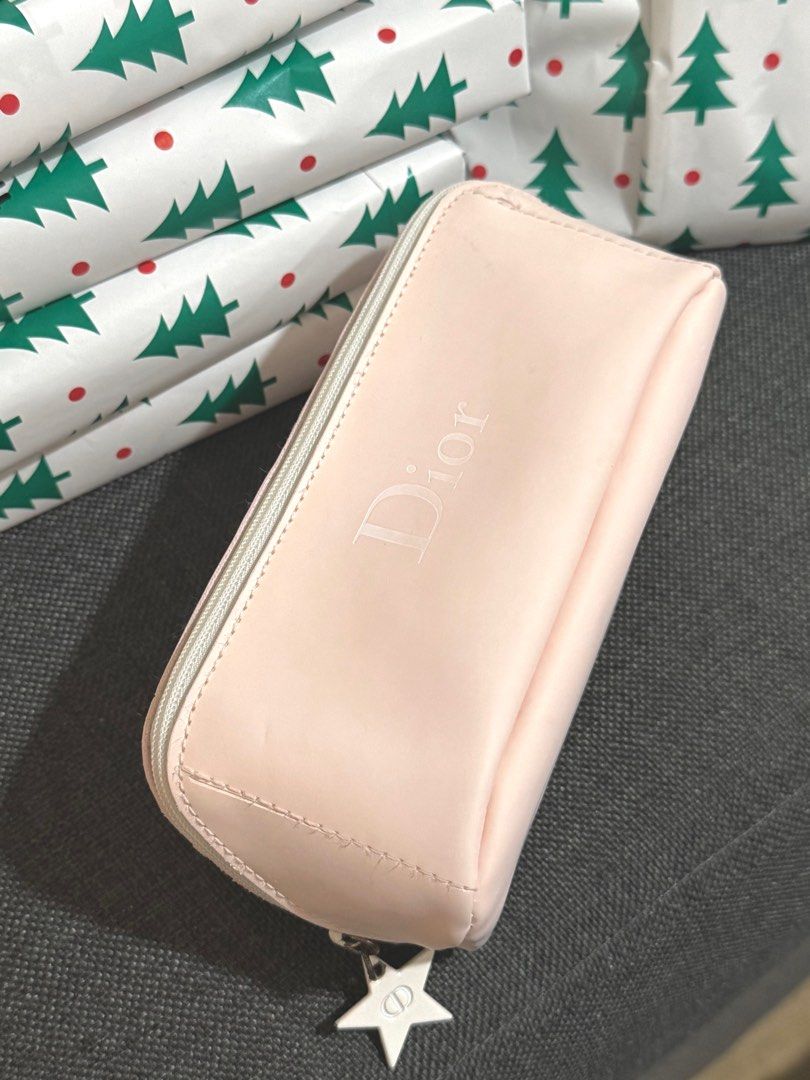 AUTHENTIC Dior Pink Cosmetic Pouch (VIP Gift) (Category: Luxury Bags & Wallets) located in Quezon City. Submitted by naptimeph (Listing ID 1409481930, Image 2). Description: - Authentic Dior cosmetic pouch - Soft pink color - Zipper closure - Adorned with a star-shaped charm - White interior lining with Dior label - Compact size, perfect for makeup or small essentials -spacious Issue: see the last 2 photos (chipped paint sa zipper & may small sta