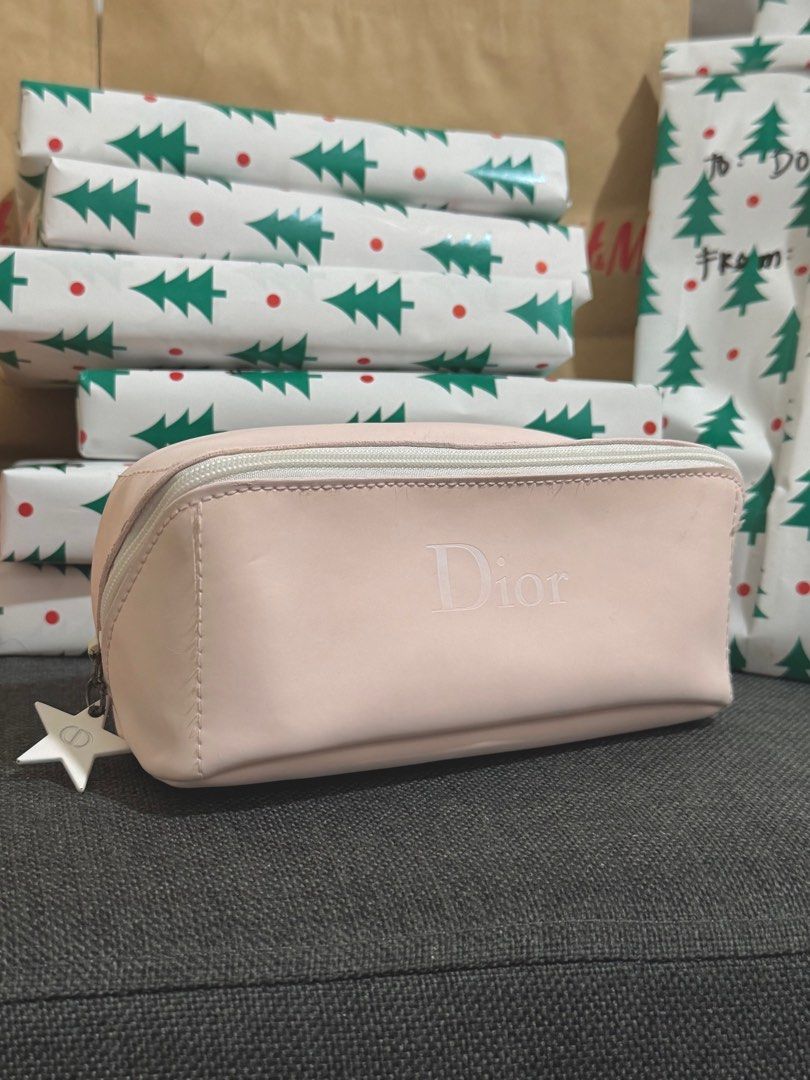 AUTHENTIC Dior Pink Cosmetic Pouch (VIP Gift) (Category: Luxury Bags & Wallets) located in Quezon City. Submitted by naptimeph (Listing ID 1409481930, Image 1). Description: - Authentic Dior cosmetic pouch - Soft pink color - Zipper closure - Adorned with a star-shaped charm - White interior lining with Dior label - Compact size, perfect for makeup or small essentials -spacious Issue: see the last 2 photos (chipped paint sa zipper & may small sta