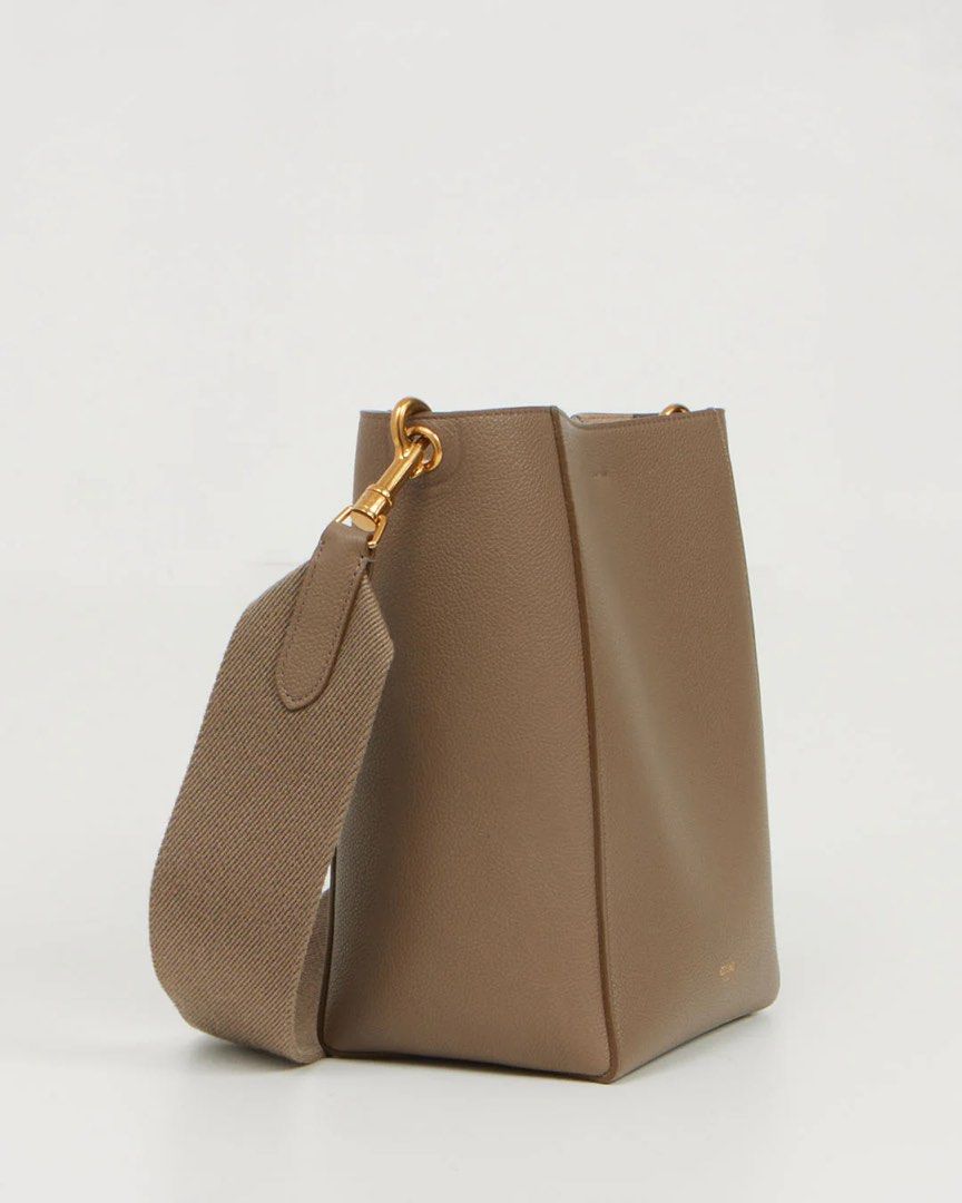 CELINE Seau Sangle Small in Taupe (Category: Luxury Bags & Wallets) located in General Trias. Submitted by frommetoyouthings (Listing ID 1409464548, Image 3). Description: From the helm of THE Phoebe Philo collection and Hedi Slimane era, this classic and classy bucket bag is a beautiful piece to add to your capsule collection. Condition: Pristine condition Dimension: L 7" x H 9.5" x W 4.75" Handle drop: 15.5" Features : Taupe grained calfskin le