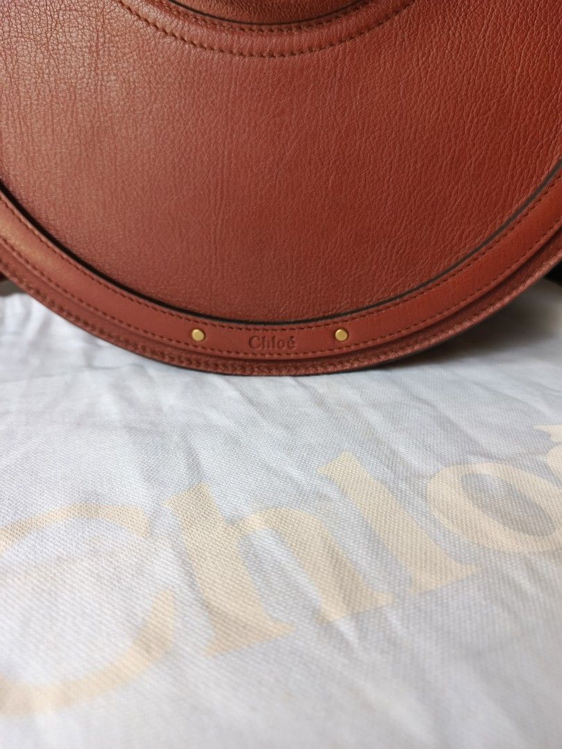 Chloe Pixie Round Bag (Category: Luxury Bags & Wallets) located in Bulacan. Submitted by zhetty_declutter (Listing ID 1409463649, Image 3). Description: - Chloe Pixie Bag - Brown leather exterior with suede panel - Unique round shape - Top handle and detachable shoulder strap - Interior zipped pocket - Gold-tone hardware - Chloe logo detail - Includes dust bag.