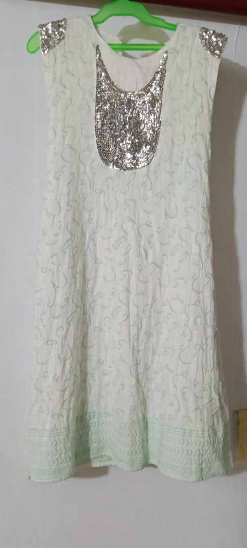 Embellished Sleeveless Dress (Category: Dresses) located in Pasig City. Submitted by ani2684 (Listing ID 1409513344, Image 3). Description: - Sleeveless dress - Intricate fabric pattern - Embellished shoulder accents - Matching belt included - Light green hem trim - Perfect for special occasions.
