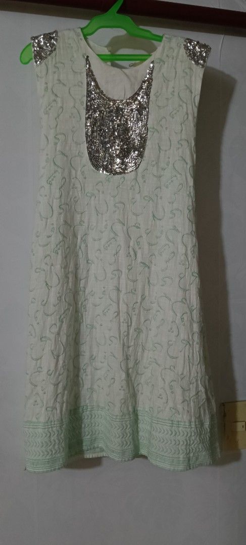 Embellished Sleeveless Dress (Category: Dresses) located in Pasig City. Submitted by ani2684 (Listing ID 1409513344, Image 2). Description: - Sleeveless dress - Intricate fabric pattern - Embellished shoulder accents - Matching belt included - Light green hem trim - Perfect for special occasions.