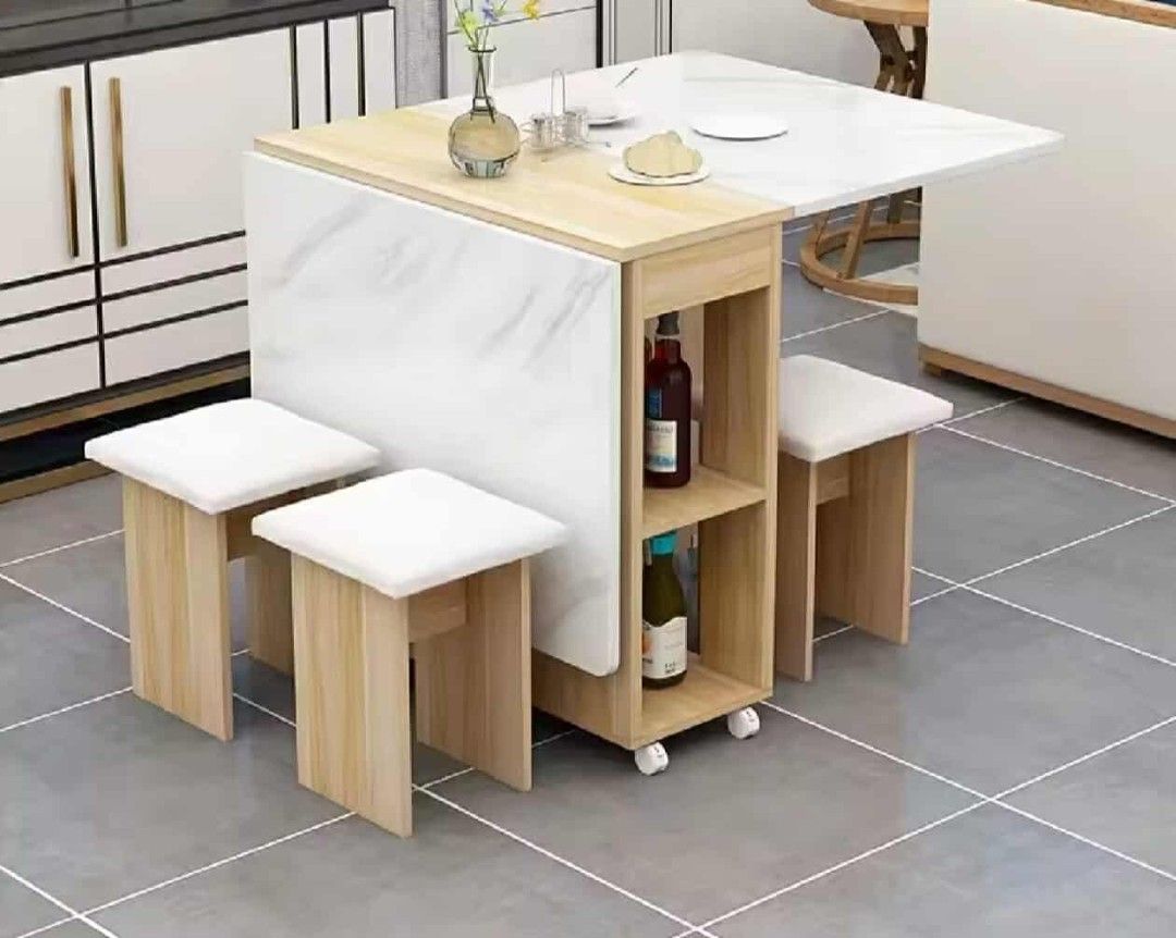 Foldable Dining Table with Stools (Category: Tables & Sets) located in Manila. Submitted by nhi_nin (Listing ID 1409576987, Image 3). Description: Versatile dining table set is perfect for small spaces. It features a foldable design for easy storage and comes with matching stools. The table has a marble-like finish and includes built-in storage shelves. It's ideal for apartments or homes where space is a premium. Dimensions are provided in the im