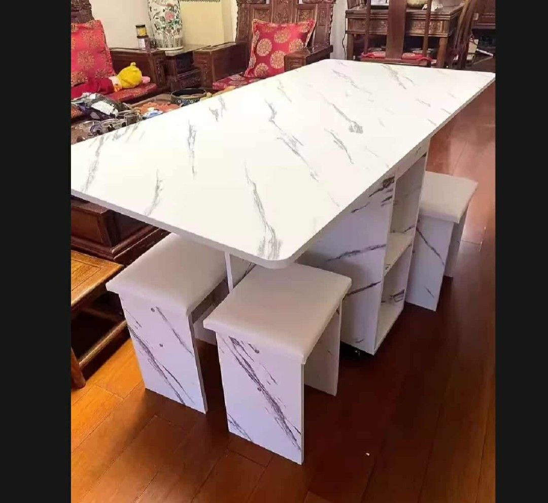Foldable Dining Table with Stools (Category: Tables & Sets) located in Manila. Submitted by nhi_nin (Listing ID 1409576987, Image 1). Description: Versatile dining table set is perfect for small spaces. It features a foldable design for easy storage and comes with matching stools. The table has a marble-like finish and includes built-in storage shelves. It's ideal for apartments or homes where space is a premium. Dimensions are provided in the im