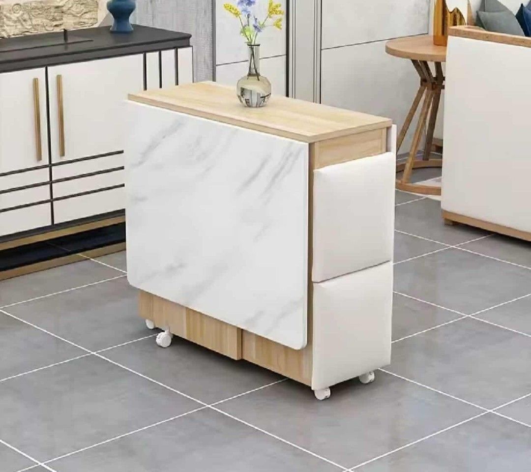 Foldable Dining Table with Stools (Category: Tables & Sets) located in Manila. Submitted by nhi_nin (Listing ID 1409576987, Image 2). Description: Versatile dining table set is perfect for small spaces. It features a foldable design for easy storage and comes with matching stools. The table has a marble-like finish and includes built-in storage shelves. It's ideal for apartments or homes where space is a premium. Dimensions are provided in the im