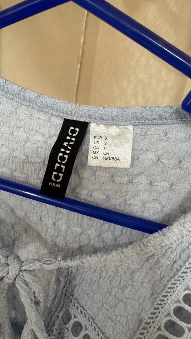 H&M Divided Top - Size S (Category: Sleeveless) located in Quezon City. Submitted by declutterrringme (Listing ID 1409496824, Image 2). Description: used once - H&M Divided light blue top - Size: S - Features: - Textured fabric - Tie detail at neckline - Eyelet detailing on yoke - Short, ruffled sleeves.