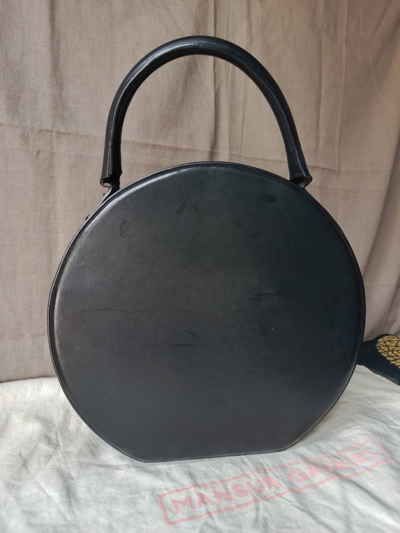Mansur Gavriel Circle Bag (Category: Luxury Bags & Wallets) located in Bulacan. Submitted by zhetty_declutter (Listing ID 1409465286, Image 2). Description: - Mansur Gavriel Circle Bag - Black leather exterior - Top handle design - Secure zip closure - Gold-toned zipper - Beige interior - Includes dust bag - Round shape.