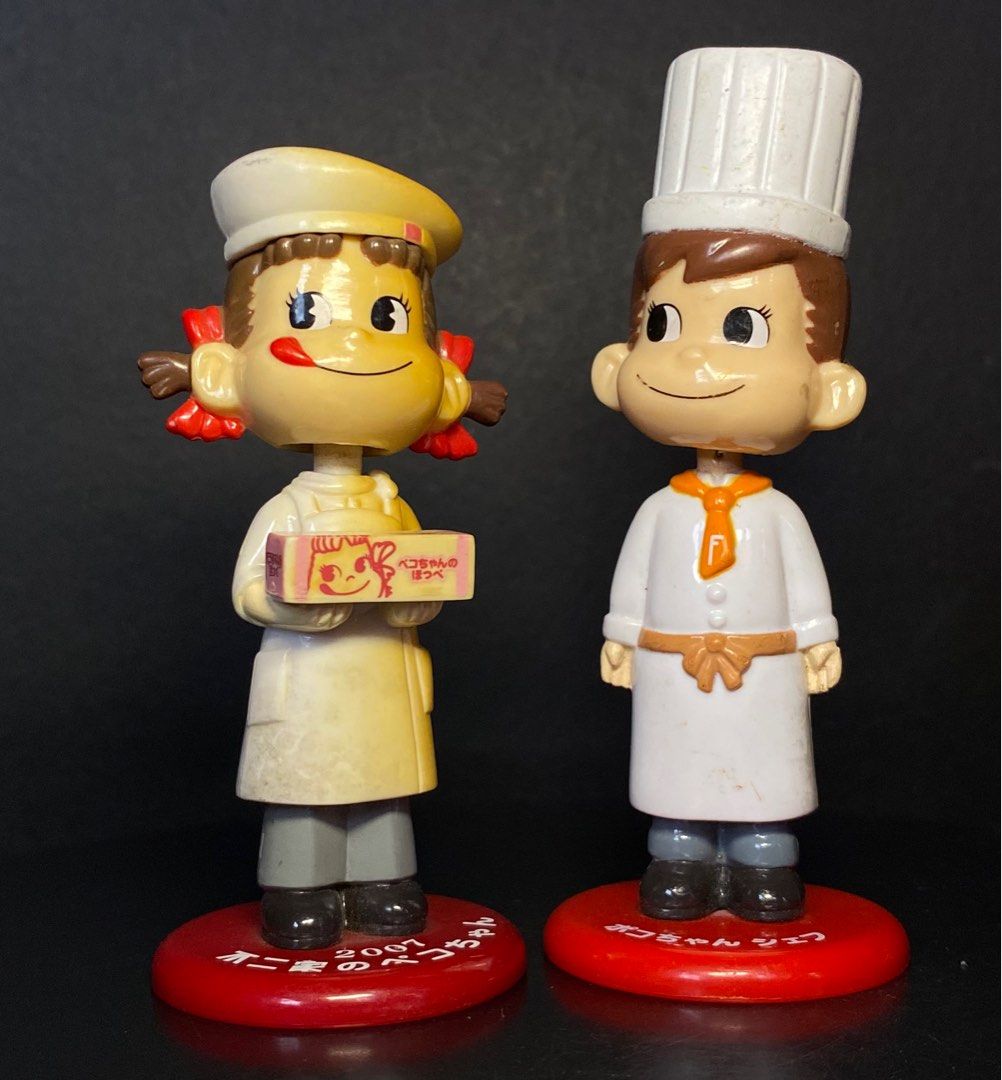 Peko and Poko chan and Chef Figure set (Category: Figurines & Statues) located in Agoo. Submitted by collect12 (Listing ID 1409549522, Image 1). Description: - Peko and Poko chan chef figure set - Includes two figurines: Peko-chan chef and male chef - Both figurines are on red bases - Peko-chan figurine has a 2001 marking - Collectible item.