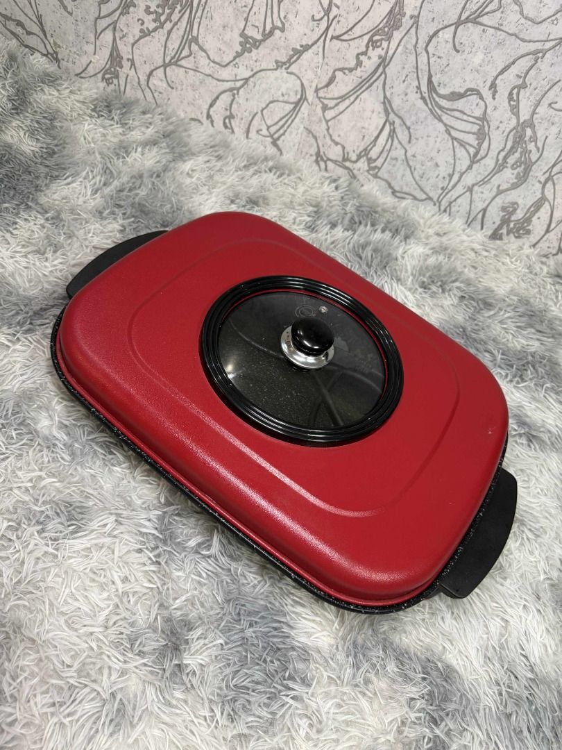 Red Electric Griddle with Glass Lid (Category: Cookware & Accessories) located in Caloocan City. Submitted by fastmountain-b80bbc (Listing ID 1409505783, Image 1). Description: Red electric griddle features a glass lid with a black handle. It has a rectangular shape with black handles on both sides. It's perfect for making pancakes, grilling vegetables, or preparing a quick meal..