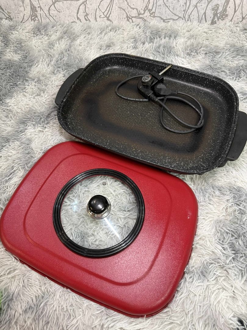 Red Electric Griddle with Glass Lid (Category: Cookware & Accessories) located in Caloocan City. Submitted by fastmountain-b80bbc (Listing ID 1409505783, Image 2). Description: Red electric griddle features a glass lid with a black handle. It has a rectangular shape with black handles on both sides. It's perfect for making pancakes, grilling vegetables, or preparing a quick meal..