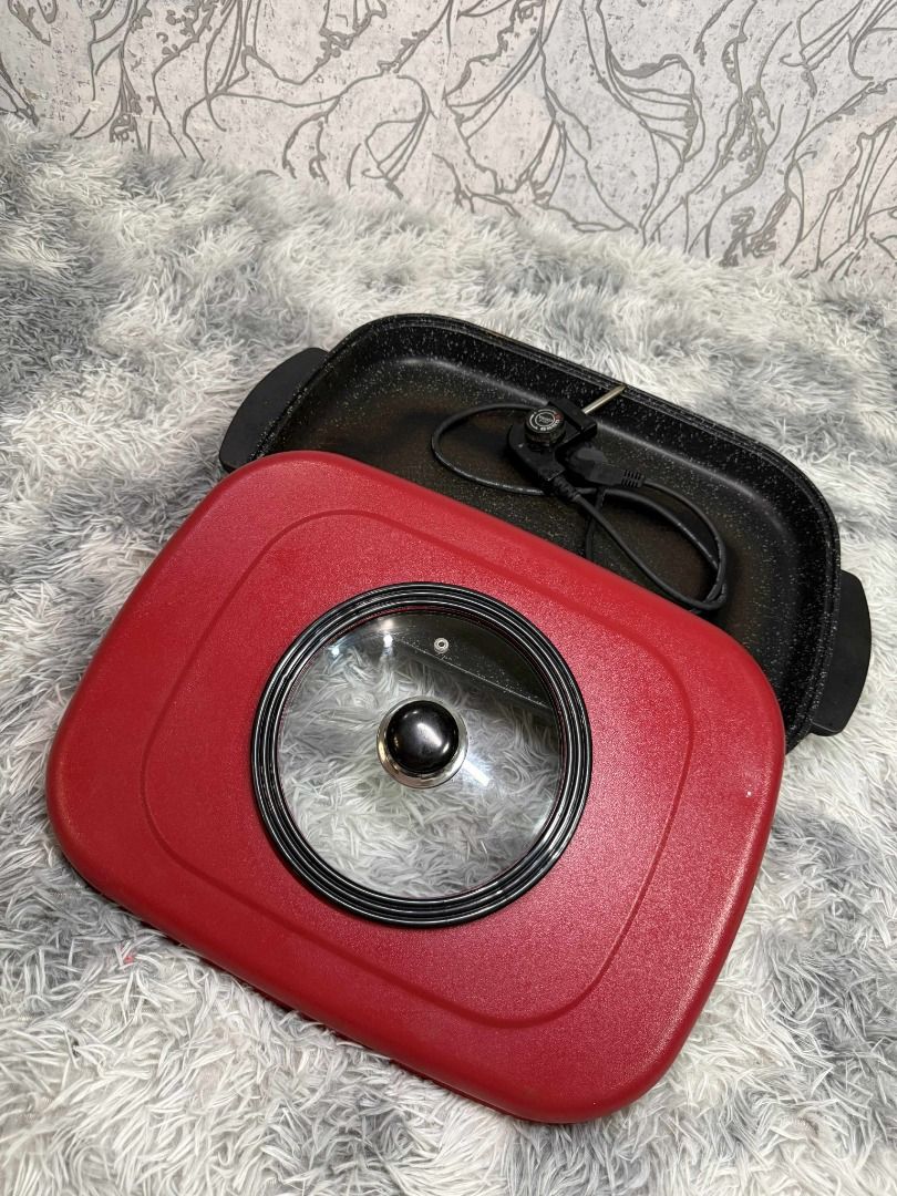 Red Electric Griddle with Glass Lid (Category: Cookware & Accessories) located in Caloocan City. Submitted by fastmountain-b80bbc (Listing ID 1409505783, Image 3). Description: Red electric griddle features a glass lid with a black handle. It has a rectangular shape with black handles on both sides. It's perfect for making pancakes, grilling vegetables, or preparing a quick meal..