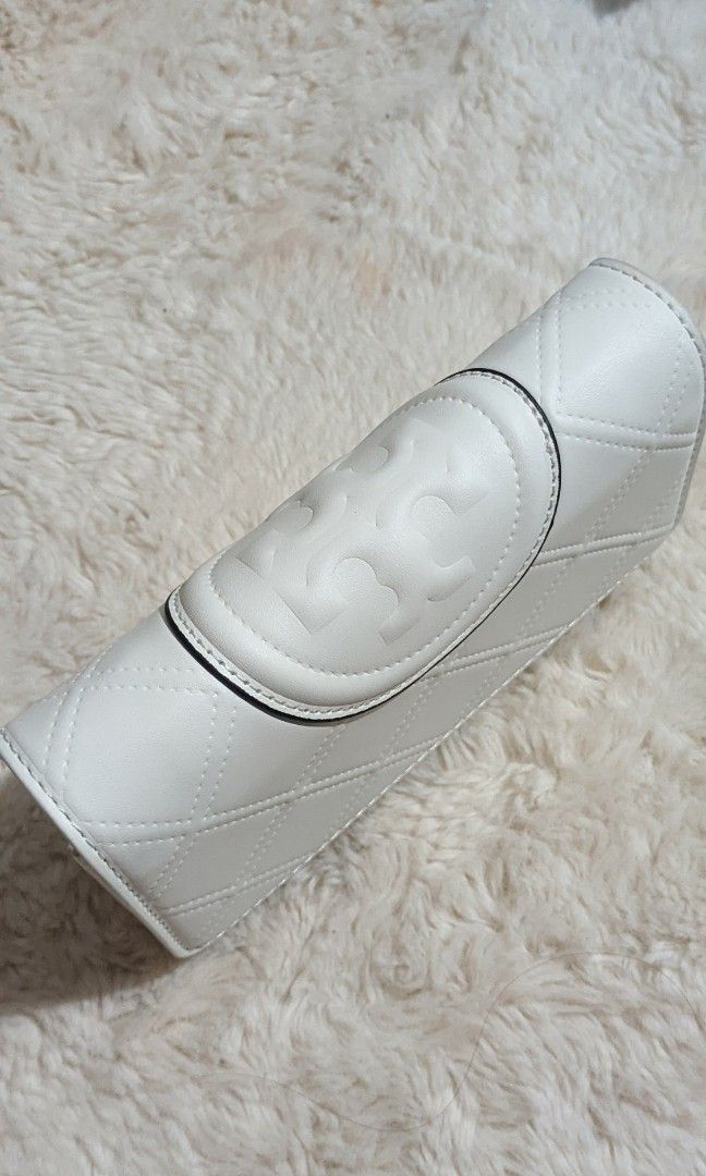 Tory Burch Kira Chevron Wallet-on-Chain (Category: Luxury Bags & Wallets) located in Manila. Submitted by aya16 (Listing ID 1409482441, Image 2). Description: - Tory Burch Kira Chevron Wallet-on-Chain - Color: White - Features: Chain strap, signature Tory Burch logo - Includes: box and dust bag - Design: Quilted - Perfect for everyday use or special events.