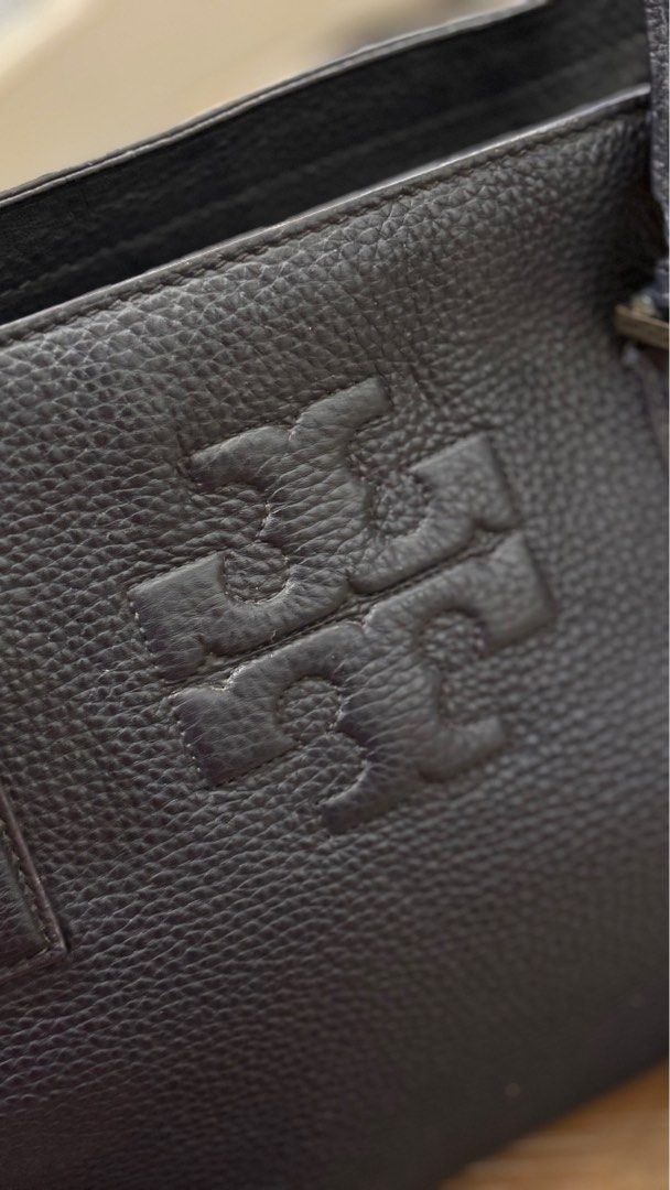 Tory Burch Navy Blue Thea Tassel Handbag (Category: Luxury Bags & Wallets) located in Paranaque City. Submitted by celina_reyes (Listing ID 1409469928, Image 3). Description: - Navy Blue leather Tory Burch handbag - Gold-tone hardware - Chain strap and detachable shoulder strap - Embossed Tory Burch logo - Stylish tassel detail - Top handle - Spacious interior.