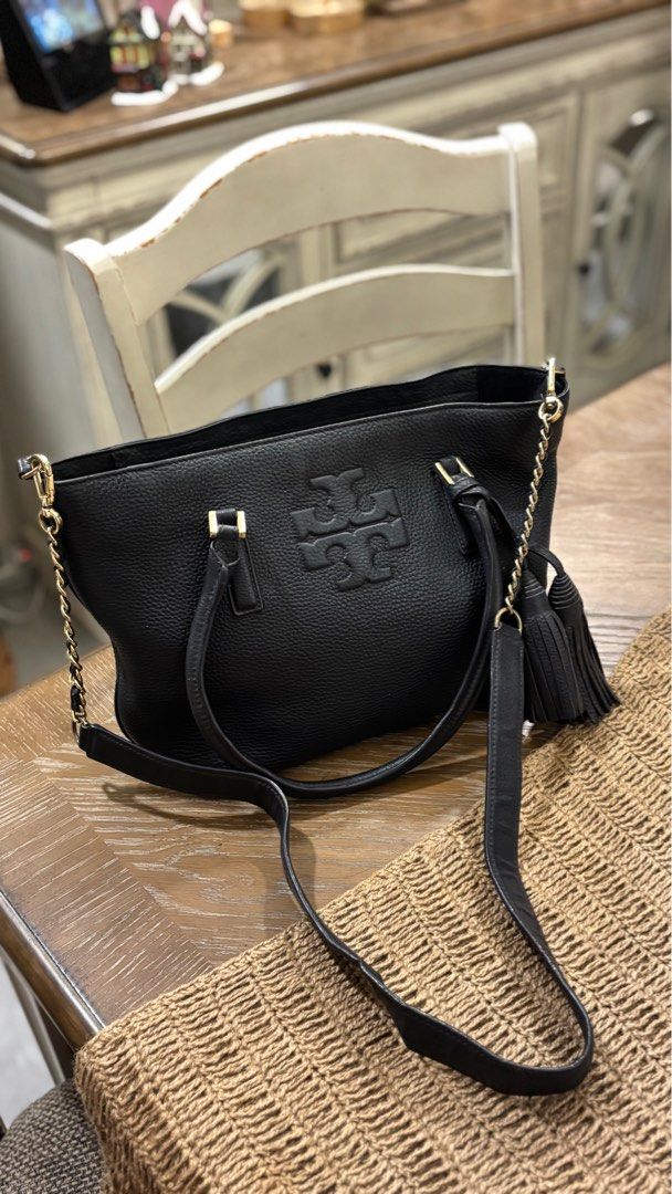 Tory Burch Navy Blue Thea Tassel Handbag (Category: Luxury Bags & Wallets) located in Paranaque City. Submitted by celina_reyes (Listing ID 1409469928, Image 1). Description: - Navy Blue leather Tory Burch handbag - Gold-tone hardware - Chain strap and detachable shoulder strap - Embossed Tory Burch logo - Stylish tassel detail - Top handle - Spacious interior.
