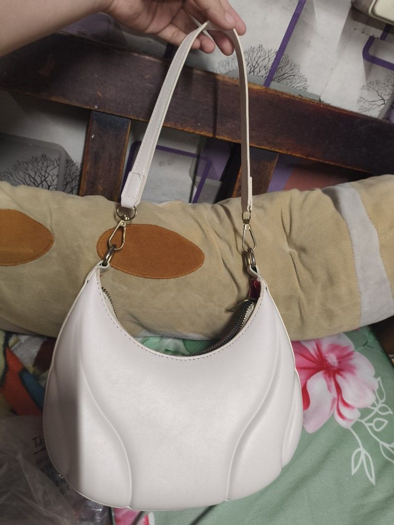 RUSH SALE! White Crescent Shoulder Bag (Category: Shoulder Bags) located in Quezon City. Submitted by cathian (Listing ID 1409534846, Image 2). Description: - Stylish white shoulder bag - Unique crescent shape - Zippered closure - Detachable strap - Red interior lining - small size signs of usage but very minimal.