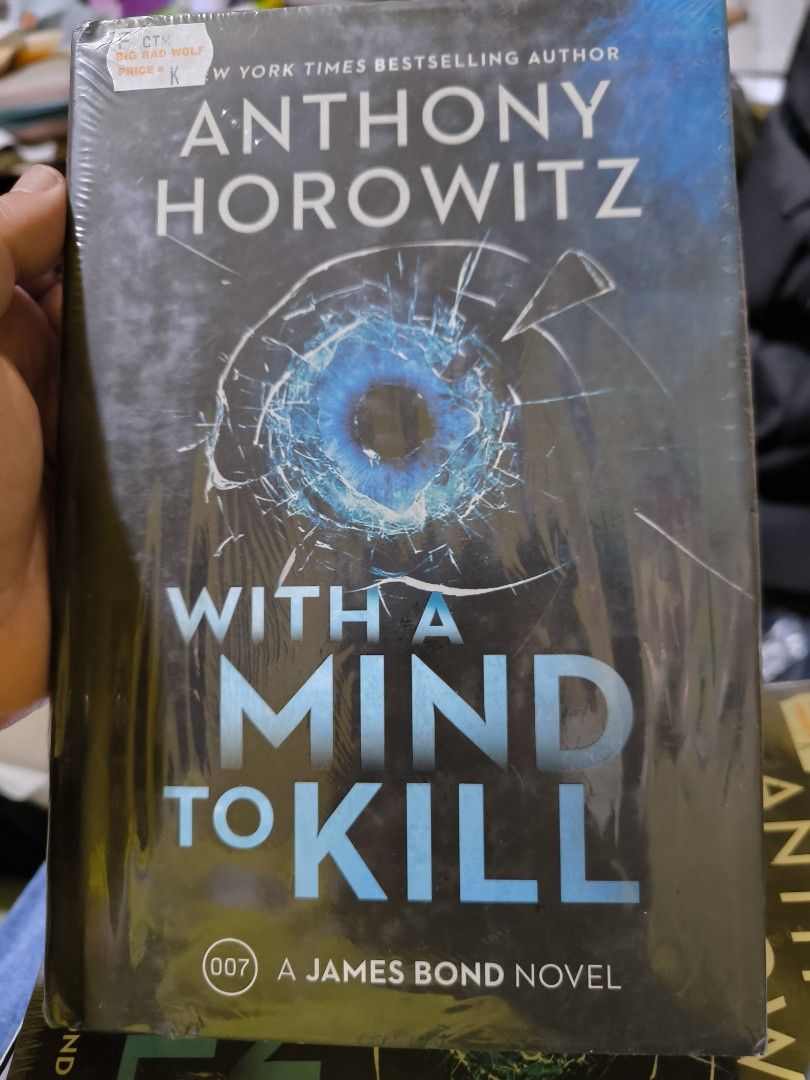 With a Mind to Kill - James Bond Novel by Anthony Horowitz (Category: Storybooks) located in Manila. Submitted by fredrk (Listing ID 1409461761, Image 1). Description: James Bond novel "With a Mind to Kill" by Anthony Horowitz. The book is still in its original packaging. The cover features a shattered glass effect with a blue center. The back of the book includes quotes from The Guardian, The Scotsman, Daily Express, and The Times. Reduced price