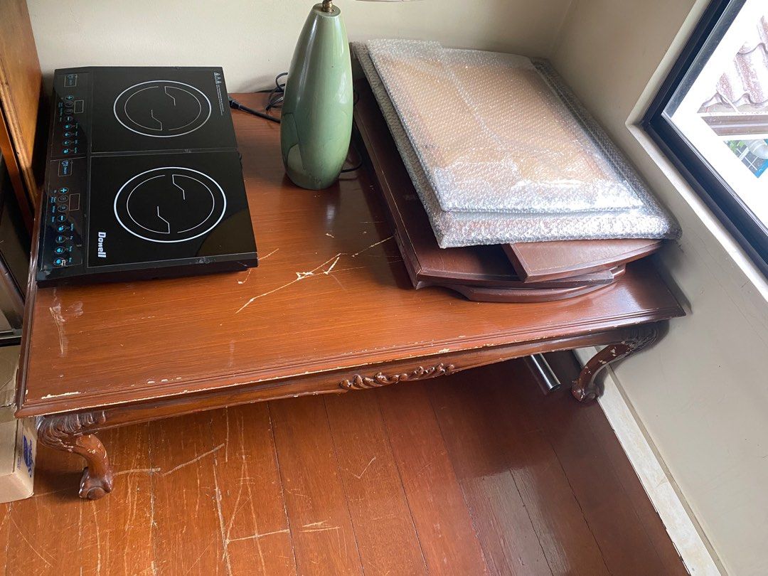 Wooden Coffee Table with Ornate Legs (Category: Tables & Sets) located in Muntinlupa City. Submitted by whiteisright (Listing ID 1409486992, Image 2). Description: - Classic wooden coffee table - Features ornate legs - Rectangular top - Ideal for living rooms and lounge areas - needs to be revarnished - 48in L / 36 in W / 18in H estimated.
