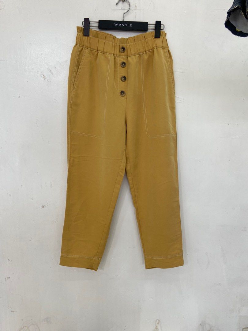 ZARA Mustard Yellow Pants (Category: Other Bottoms) located in San Fernando. Submitted by 4ases.declutter (Listing ID 1409456894, Image 1). Description: - Mustard yellow pants from Zara - Button-up front - Elastic waistband - Relaxed fit - Cropped length - Visible stitching on front pockets and seams - Plain back (no pockets).