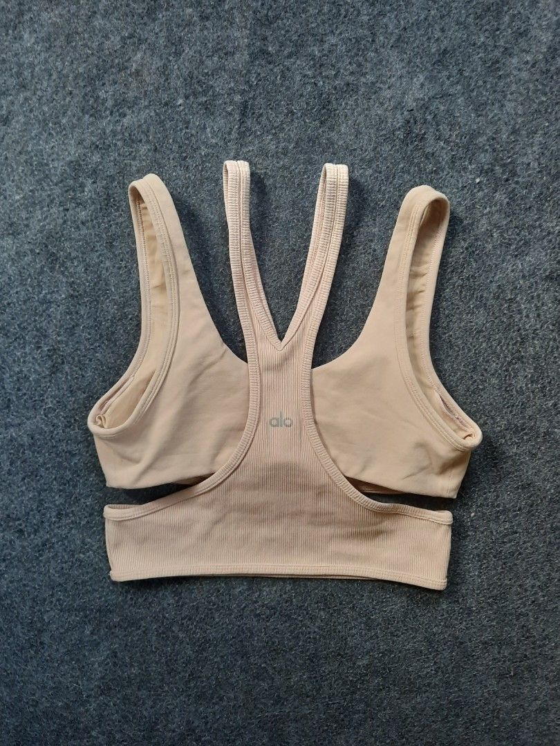 Alo Yoga Trackie Sports Bra long line cage cut out (Category: Activewear) located in San Jose del Monte. Submitted by leslymhey (Listing ID 1409620280, Image 1). Description: - Beige Alo Yoga sports bra - Size: M - Features a unique strappy design - Ribbed detailing - Padded - Comfortable and stretchy fabric - Ideal for yoga, pilates, and workouts.