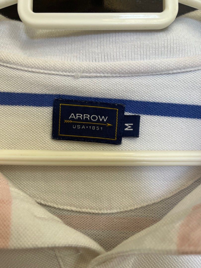 Arrow Striped Polo Shirt - Medium (Category: Tshirts & Polo Shirts ) located in Santa Rosa. Submitted by declutter.jenjen (Listing ID 1409631416, Image 2). Description: - personal item -Arrow polo shirt, size medium. - Striped design with a classic collar. - Short sleeves. - White base color with blue, orange, and pink stripes. - Button-up placket. - Arrow logo on the chest..