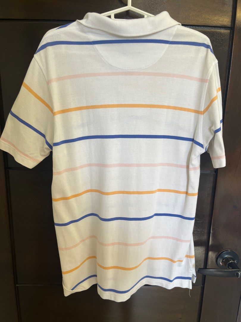 Arrow Striped Polo Shirt - Medium (Category: Tshirts & Polo Shirts ) located in Santa Rosa. Submitted by declutter.jenjen (Listing ID 1409631416, Image 3). Description: - personal item -Arrow polo shirt, size medium. - Striped design with a classic collar. - Short sleeves. - White base color with blue, orange, and pink stripes. - Button-up placket. - Arrow logo on the chest..