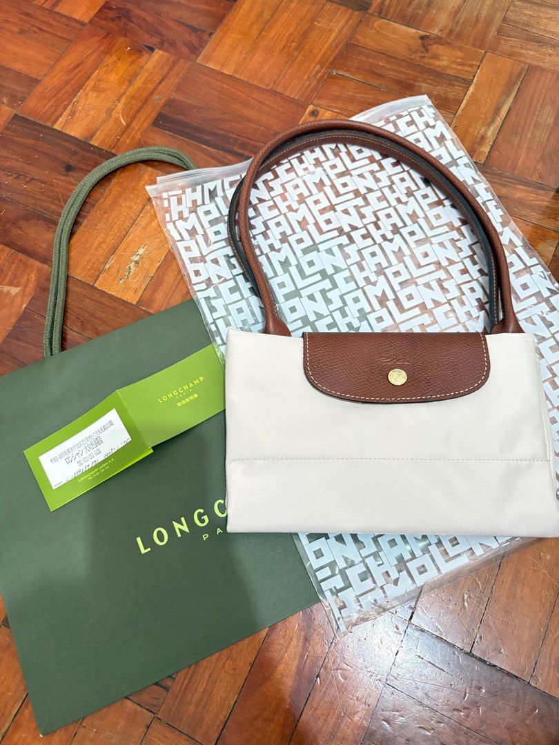 Authentic Le Pliage Original Tote Bag L Paper (Category: Luxury Bags & Wallets) located in Orion. Submitted by alyssamint (Listing ID 1409690414, Image 1). Description: Authentic Le Pliage Original Tote Bag L Large size Color Paper Bought from Longchamp Daimaru Sapporo, Japan last Jan 2025 Used 3x RFS: I already have this in black, which I use more often.