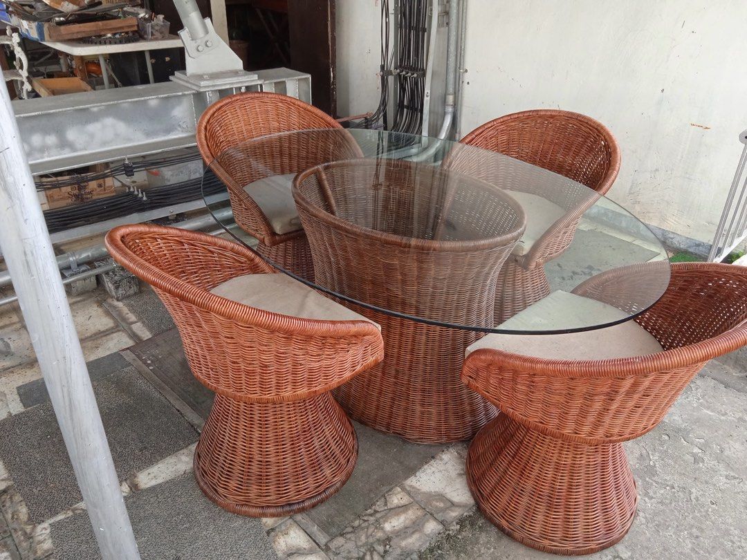 Authentic rattan wicker dining table and chairs set (Category: Tables & Sets) located in Makati City. Submitted by pjstyle (Listing ID 1409783040, Image 2). Description: Authentic rattan (not plastic, not synthetic) wicker table set. 62-1/2” long x 44” width x 1/2” thick oval glass table with 4 cushioned rattan seats. Perfect for outdoor dining or adding natural style. Pick up location in Old Sta. Mesa, Manila near Lourdes Hospital..