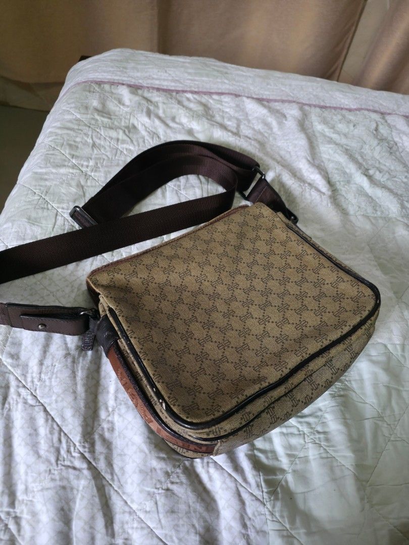 Balenciaga Patterned Messenger Bag (Category: Luxury Bags & Wallets) located in Quezon City. Submitted by mightywind.4469d6 (Listing ID 1409624499, Image 2). Description: - Balenciaga messenger bag - Brown and black patterned exterior - Shoulder strap and top handle - Zipper closure - Interior compartment - Brand name visible on strap - Stylish and functional design size: 9in x 10 in.