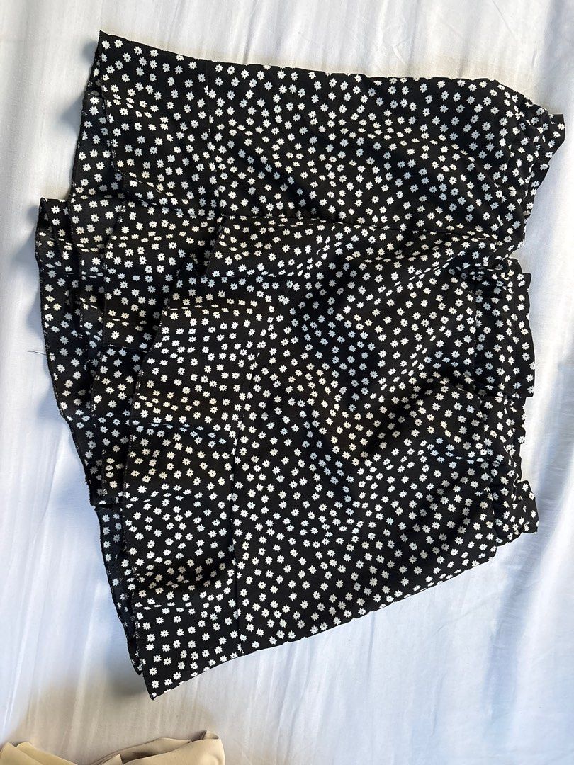 Black Floral Skirt (Category: Skirts) located in Quezon City. Submitted by authentic_c (Listing ID 1409672365, Image 1). Description: - Black skirt with white floral pattern - Features a ruffled hem - Comfortable elastic waistband - Made of lightweight fabric - Ideal for warm weather - Versatile style for casual wear Shein skort.