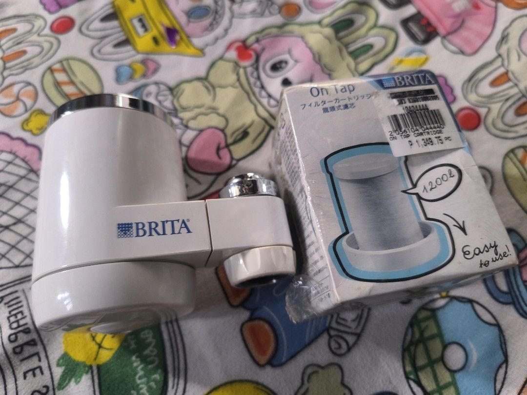 Brita On Tap Water Filter (Category: Water Purifiers & Dispensers) located in Manila. Submitted by bartolomekuma20 (Listing ID 1409654089, Image 1). Description: - Brita On Tap water filter included. - Comes with filter cartridge. - Filters up to 1200L of water. - Easy to use and install. - Features a white body with silver accents. - Brita logo visible..
