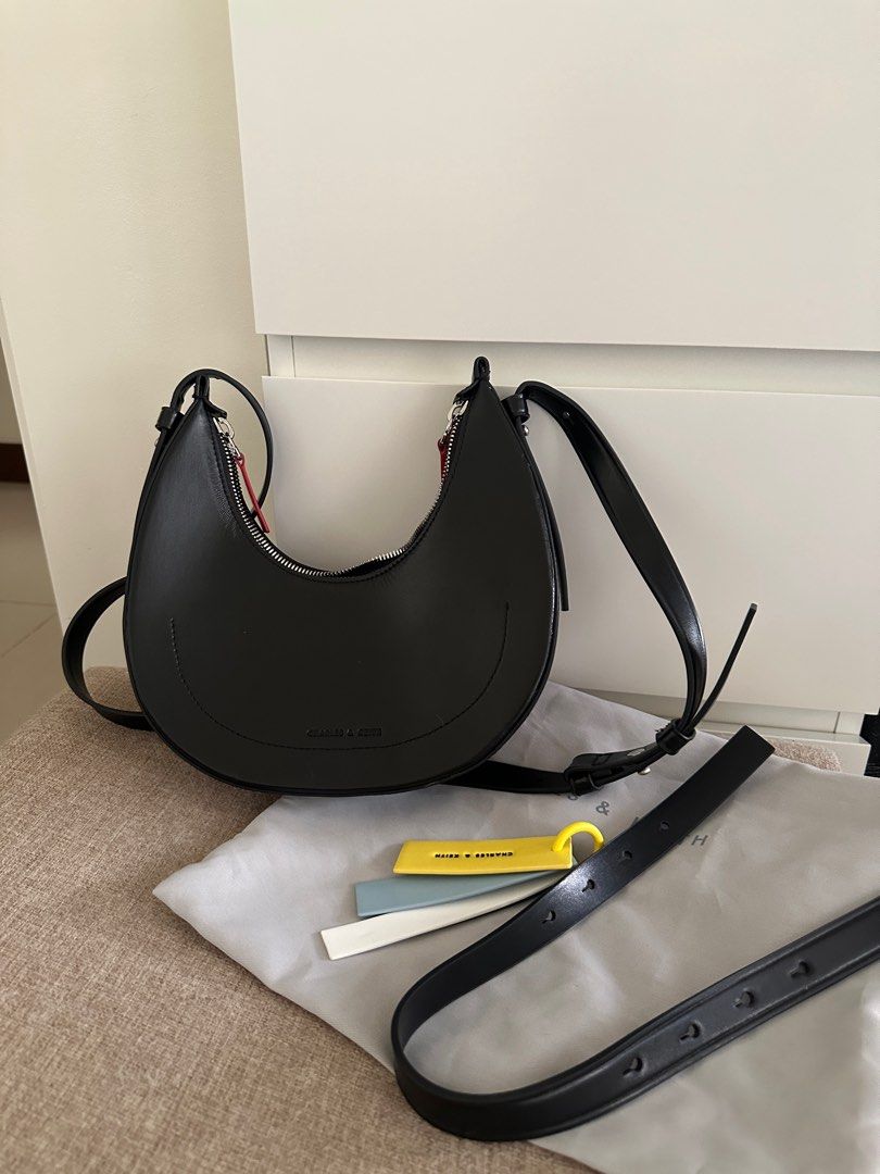 Charles & Keith Noir Carey Crescent Bag (Category: Luxury Bags & Wallets) located in Taguig. Submitted by declutterwithjoey (Listing ID 1365066706, Image 2). Description: Charles & Keith Noir Carey Crescent Bag - Seldomly used - No issues, with straps and keychains - Retails ₱3xxx - RFS: too many bags DECLUTTER WITH ME 🧹 PAMIGAY PRICE ‼️ - All items authentic unless stated no brand - Pay as you order basis. First to pay gets item ▪️📍Taguig ▪️ g