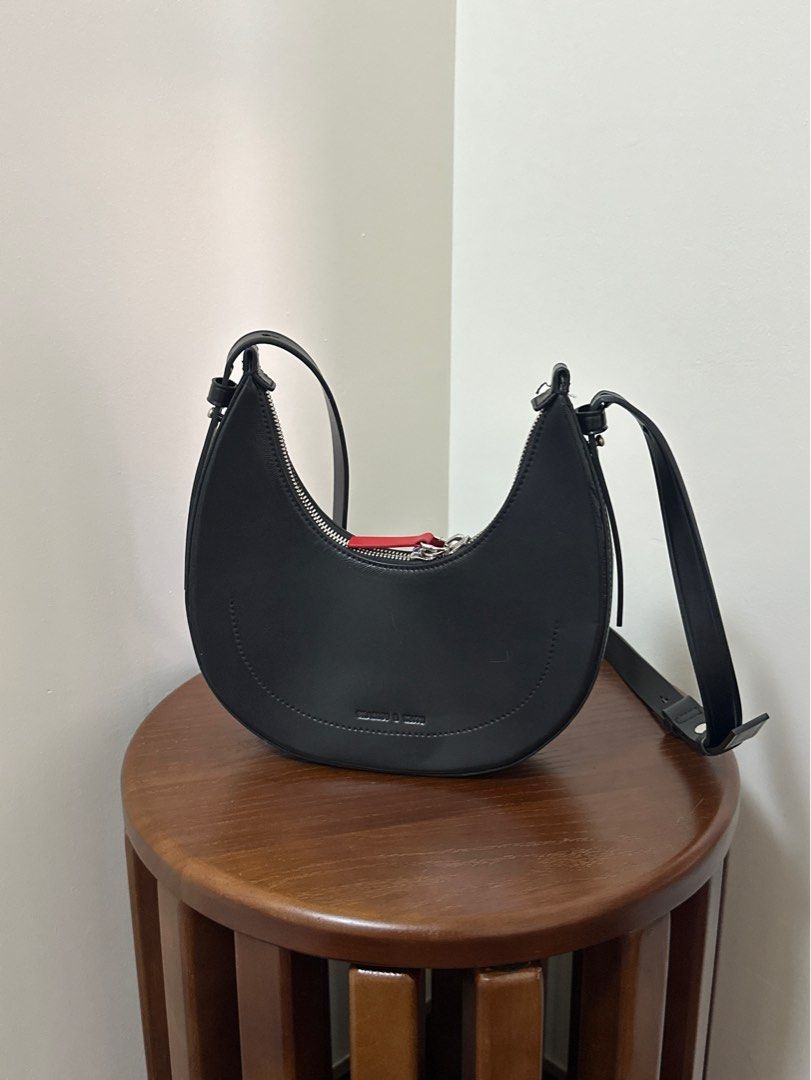 Charles & Keith Noir Carey Crescent Bag (Category: Luxury Bags & Wallets) located in Taguig. Submitted by declutterwithjoey (Listing ID 1365066706, Image 1). Description: Charles & Keith Noir Carey Crescent Bag - Seldomly used - No issues, with straps and keychains - Retails ₱3xxx - RFS: too many bags DECLUTTER WITH ME 🧹 PAMIGAY PRICE ‼️ - All items authentic unless stated no brand - Pay as you order basis. First to pay gets item ▪️📍Taguig ▪️ g