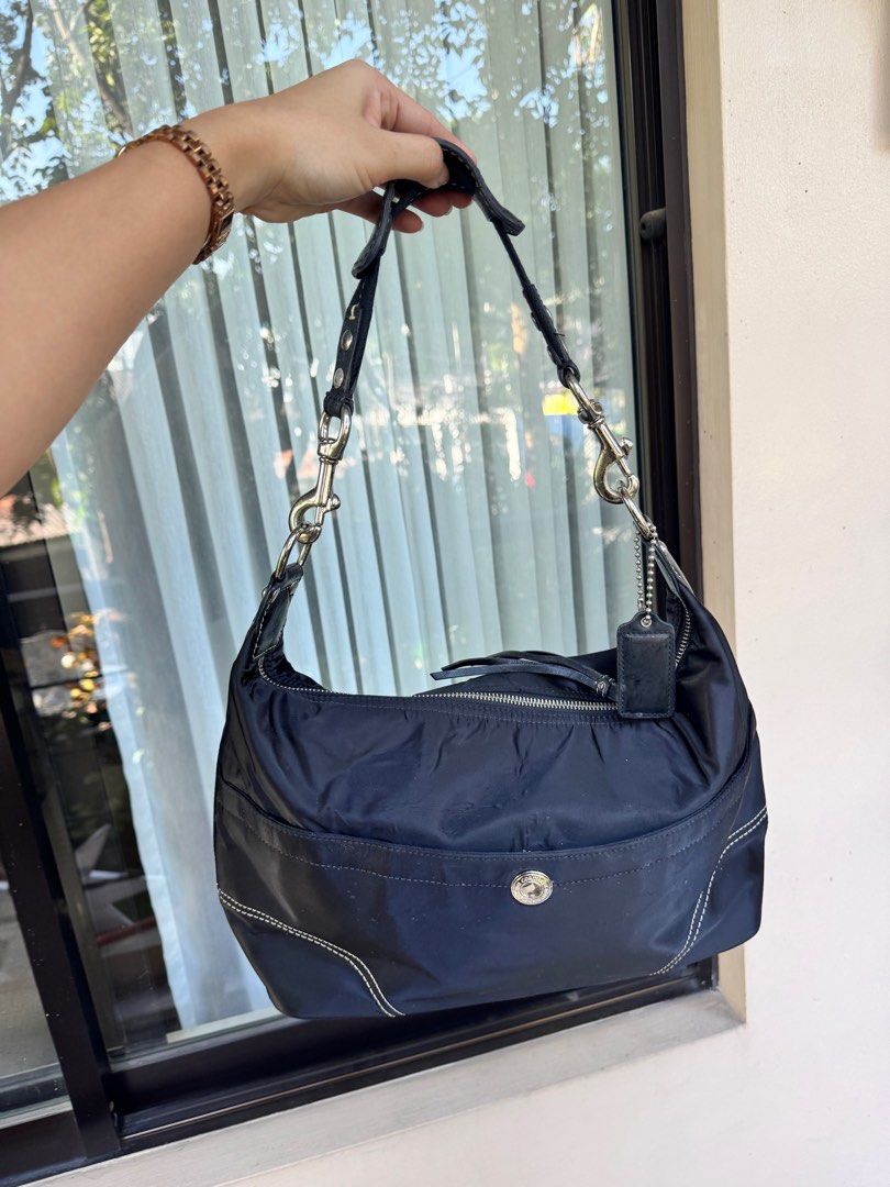 Coach Black Nylon Shoulder Bag (Category: Luxury Bags & Wallets) located in Mandaluyong City. Submitted by salefromcc (Listing ID 1409699870, Image 1). Description: Seconhand Coach Bag Bought from Japan Small Size - Authentic Coach shoulder bag - Durable nylon exterior with leather accents - Silver-tone hardware - Secure zip closure - Interior pocket - Light purple interior lining - Includes Coach leather tag - Model number: N9M0972-F11889 🎉Lowe