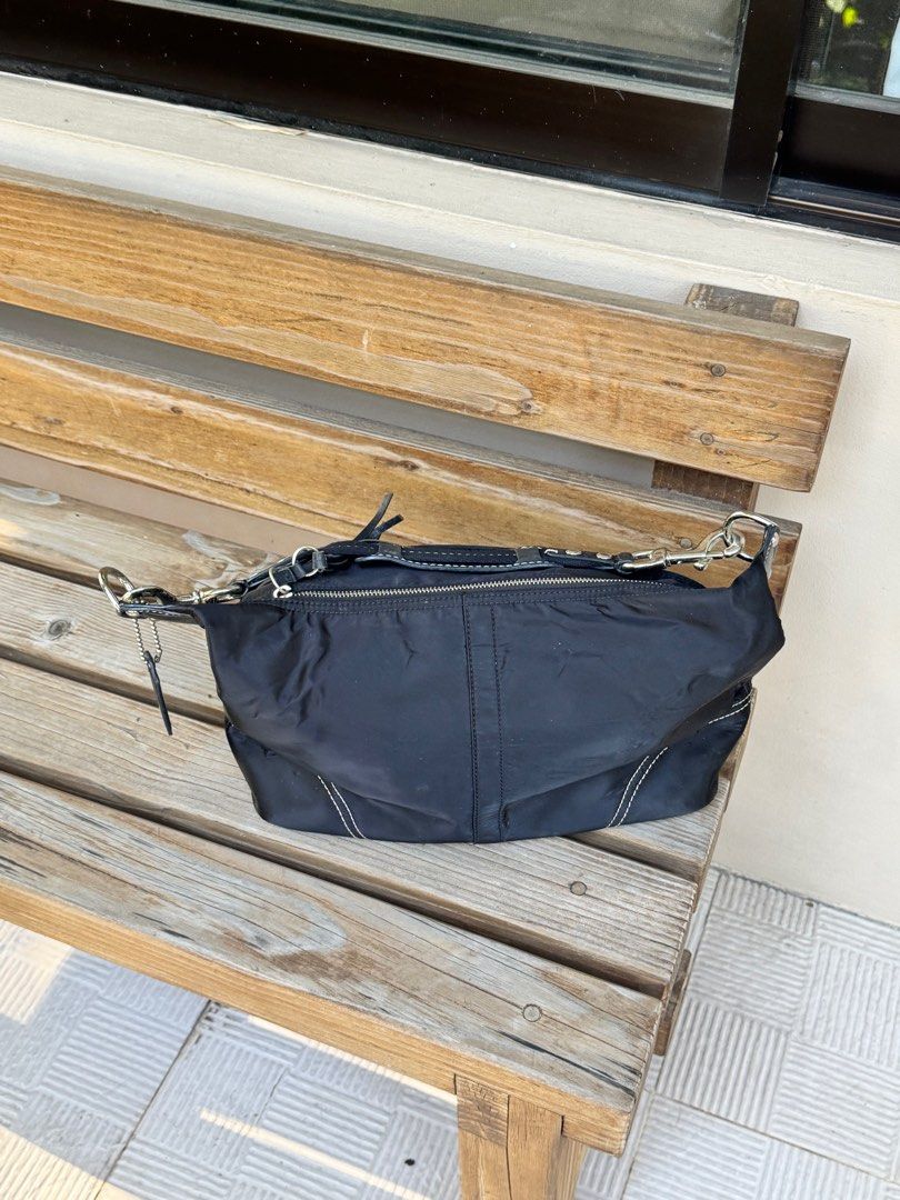 Coach Black Nylon Shoulder Bag (Category: Luxury Bags & Wallets) located in Mandaluyong City. Submitted by salefromcc (Listing ID 1409699870, Image 2). Description: Seconhand Coach Bag Bought from Japan Small Size - Authentic Coach shoulder bag - Durable nylon exterior with leather accents - Silver-tone hardware - Secure zip closure - Interior pocket - Light purple interior lining - Includes Coach leather tag - Model number: N9M0972-F11889 🎉Lowe