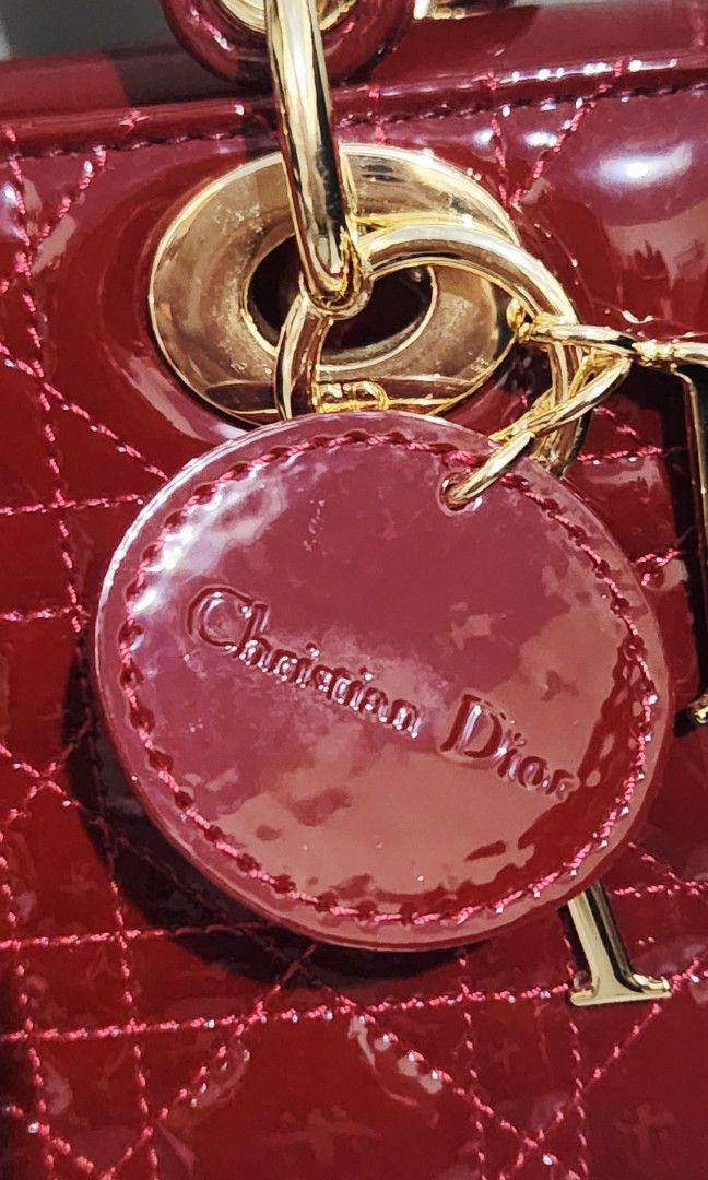 Dior Lady Dior Mini Bag (Category: Luxury Bags & Wallets) located in Mabini. Submitted by wearandcarry (Listing ID 1409213891, Image 3). Description: - small Lady Dior bag - Burgundy patent calfskin - Iconic Cannage stitching - Top handle - Detachable shoulder strap - Gold-tone hardware - Signature Dior charms - Stylish and compact.