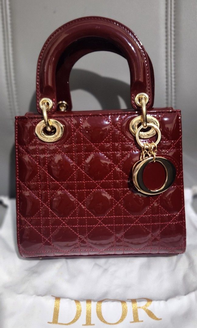 Dior Lady Dior Mini Bag (Category: Luxury Bags & Wallets) located in Mabini. Submitted by wearandcarry (Listing ID 1409213891, Image 2). Description: - small Lady Dior bag - Burgundy patent calfskin - Iconic Cannage stitching - Top handle - Detachable shoulder strap - Gold-tone hardware - Signature Dior charms - Stylish and compact.