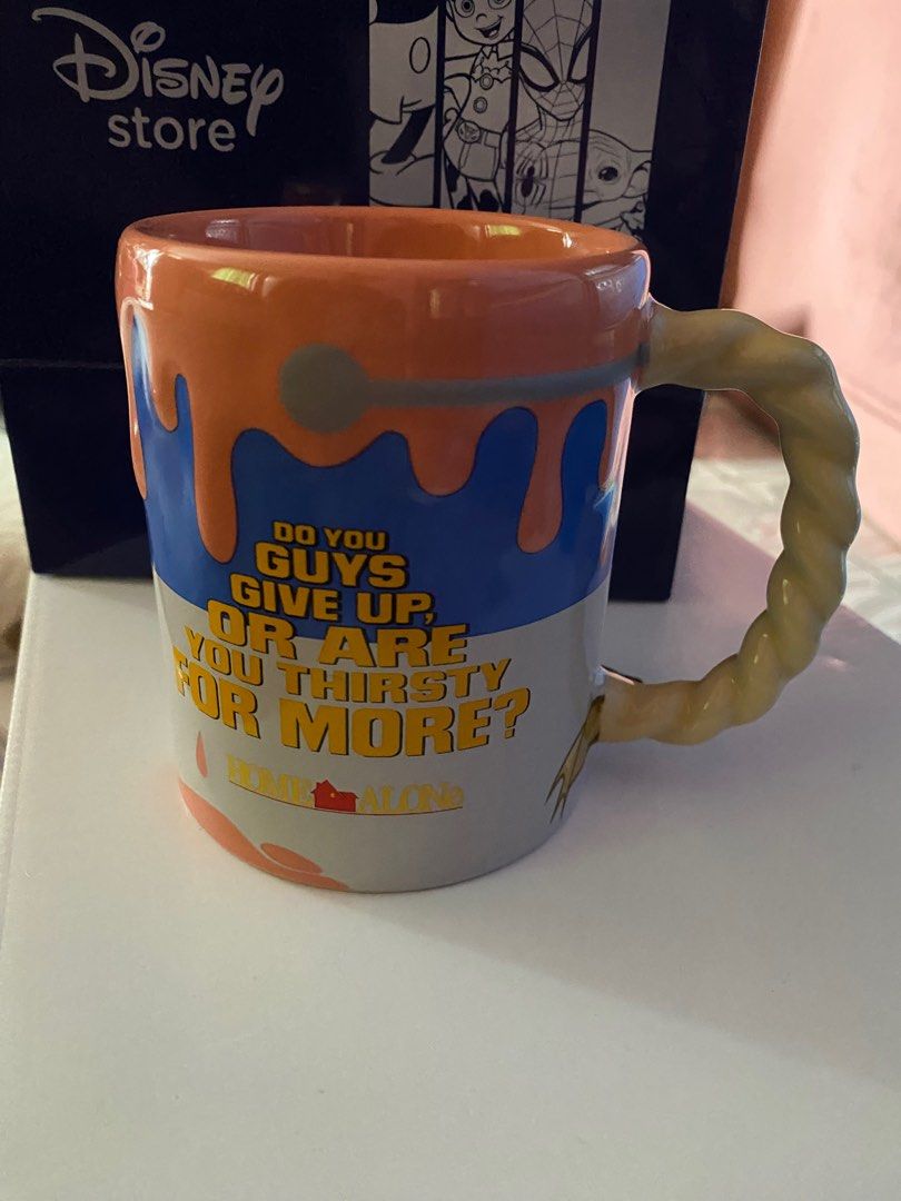 Disney Home Alone Mug (Category: Coffee & Tea Tableware) located in Pasig City. Submitted by bartbuy (Listing ID 1409625056, Image 2). Description: - Home Alone themed mug - Features characters and quotes from the movie - Unique twisted handle - Colorful design - From the Disney Store - Price: P1,149.00 -Height: 4 Inches .